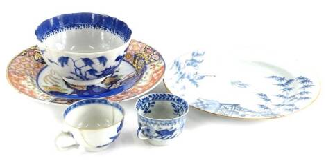 A Chinese export blue and white plate, decorated with geese, bamboo and a terrace, in blue within a brown glazed border, 23cm diameter, a Chinese export blue and white bowl, an Imari plate, and two blue and white cups, (all AF)