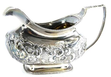 A George IV rectangular squat shaped milk jug, scrolls etc., on a domed foot with gadrooned border, London 1829, 5oz.