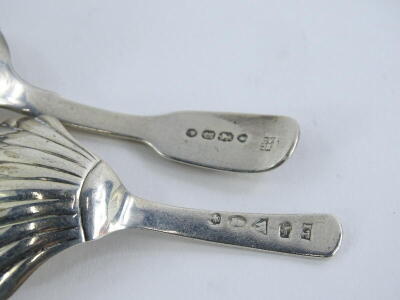 A Victorian silver fiddle pattern caddy spoon, London 1850, and another earlier example, marks indistinct, ¾oz overall. - 2