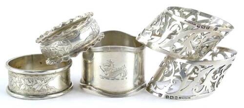 A collection of five early 20thC napkin rings, to include a pair with pierced borders, (AF), 3¼oz.