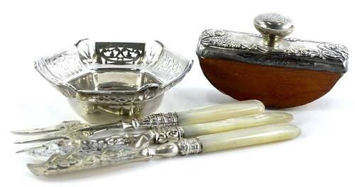 A collection of small silver and silver mounted items, to include two butter knives, a small fork, a blotter with wooden base, and a pierced silver bonbon dish, various dates, etc.