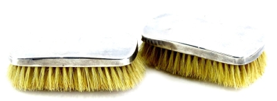 A pair of George VI silver mounted clothes brushes, London 1945.