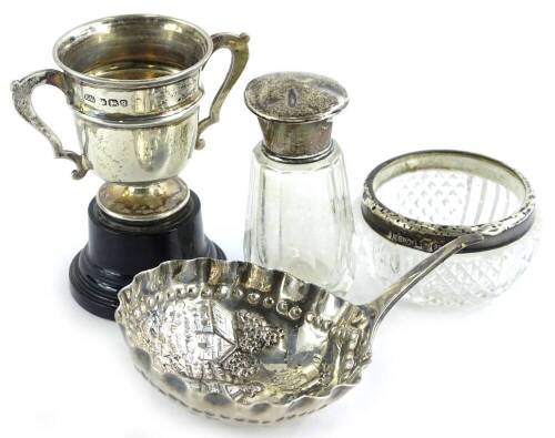 A collection of small silver mounted items, to include a two handled trophy, a Dutch spoon (AF), a salt and a small scent bottle, (4).