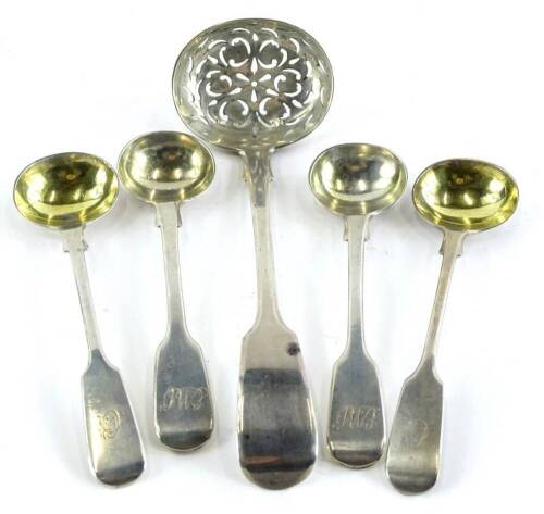 Four fiddle pattern silver mustard spoons, each with an engraved handle and a fiddle pattern sifter spoon, 2¾oz.