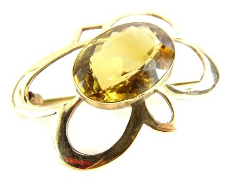 A 9ct gold cluster brooch, with central oval citrine, in floral design frame, on single pin back, 5cm x 3cm.