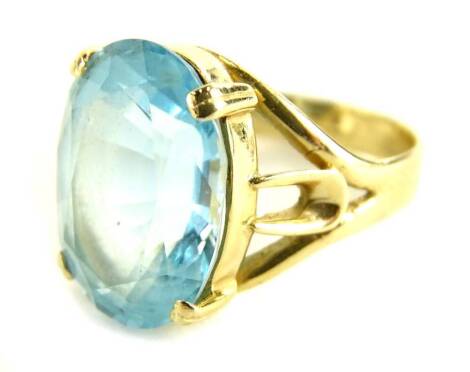 A silver dress ring, set with large blue paste stone, on gold coloured silver band, ring size P.