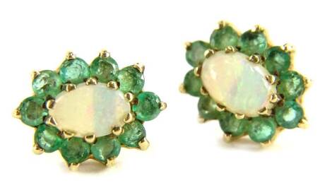 A pair of 9ct gold emerald and opal stud earrings, each cluster with central opal surrounded by emeralds, in claw setting, on single pin back, lacking butterfly backs, 1.7g all in.