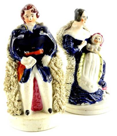 A pair of 19thC Staffordshire figures, Queen Victoria and Prince Albert seated with a baby, 14cm high.