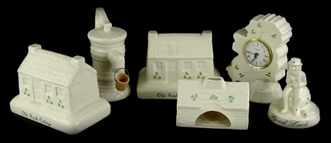 A quantity of Donegal Belleek items, to include two old Irish cottages, 18cm wide, a water pump, a clock map of Ireland, a good luck leprechaun, and a pastille burner stamped Belleek, (a quantity).