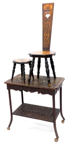 An Edwardian chip carved two tier occasional table, on later castors, a poker work and carved small footstool, and a spinning or Welsh chair bearing initials F A, etc.