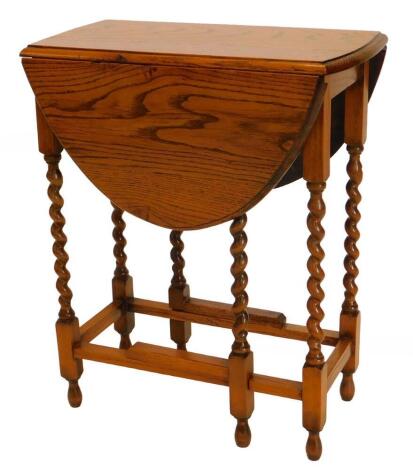 An oak oval gateleg table, on barley twist legs, 59cm wide.