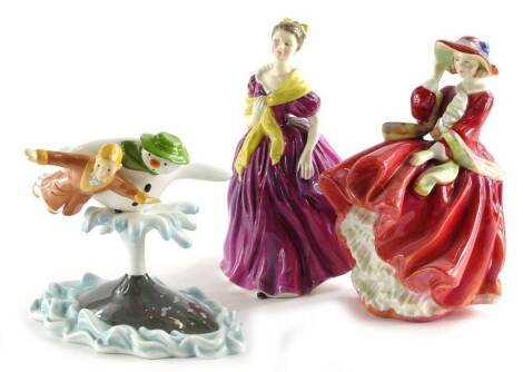 A Coalport Characters Walking On The Snowman figure group, a limited edition figure number 727 of 2000, and two Royal Doulton figurines, Top o' the Hill and Adrienne (3).