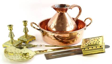 Miscellaneous brass, to include a two handled pan, flagon, a pair of candlesticks, chestnut roaster, skimmer, etc.