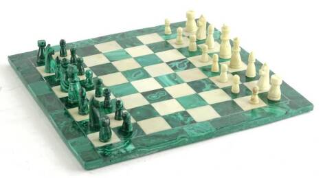 An onyx and white alabaster chess set and board, 29cm square.