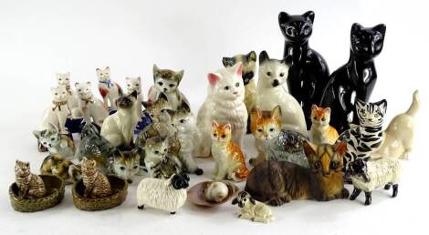 A collection of ceramic cats, to include a Wade examples, Royal Doulton Siamese cat, Staffordshire type cats, three sheep etc. (2 trays).