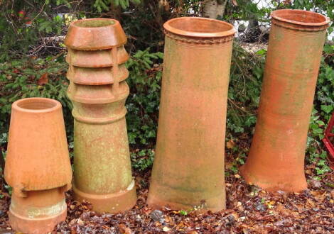 Three large teracotta chimney pots, of differing designs, the smaller example, etc., 92cm, 89cm, 91cm and 60cm high respectively.