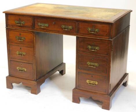 A late 19thC mahogany pedestal desk, the top with a brown leather inset and a moulded edge, above an arrangement of nine drawers on bracket feet, 104cm wide. Auctioneer announce - the right pedestal is cupboard with false drawers and not drawers.