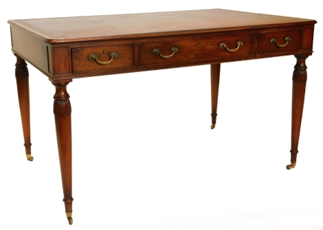 A mahogany writing table in early 19thC style, the rectangular top with a brown leather inset and a moulded edge, above three frieze drawers, on turned tapering part fluted legs, with brass castors, 75cm high, 127cm wide, 83cm deep.