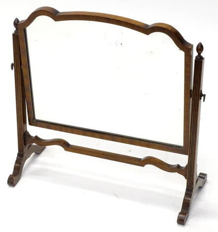 A mahogany swing frame dressing table mirror, the shaped plate on reeded tapering supports, with splayed legs, 55cm wide.