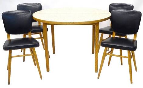 A set of four 1950s/60s dining chairs, each with a black leatherette padded back, on beech turned tapering legs with stretchers, and a similar extending dining table with a patterned melamine top, lacking extension, 105cm diameter.