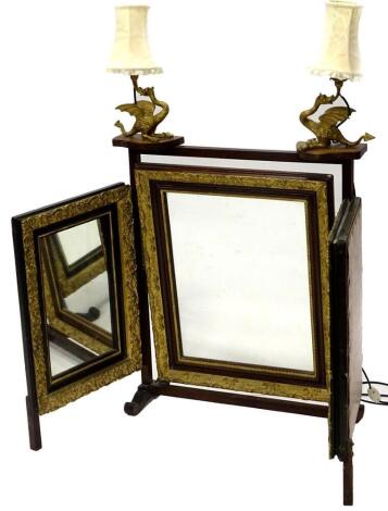 An unusual mahogany parcel gilt and painted triple mirror, with applied gilt metal dragon light fittings and shades, 102cm high, 126cm wide.