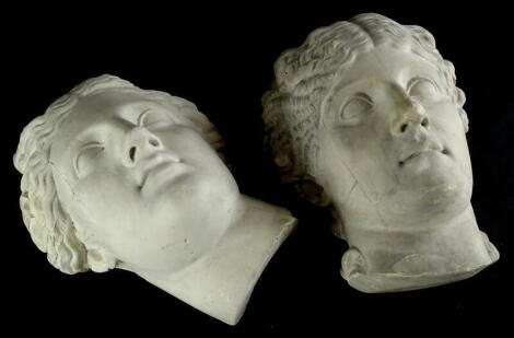 Two similar plaster wall masks, each cast in neoclassical style in the form of gentlemen, one stamped to underside D.Brucciani, London number 244, the other stamped R (AF), 28cm and 27cm high respectively.