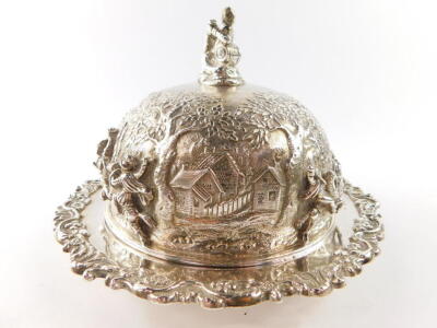 A George IV silver muffin dish and cover, the domed cover with a finial of a seated man with dog, smoking a pipe and holding a mug of ale, chased with figures from the crusades, embossed and engraved with trees and homesteads, the dish with a floral and f - 4