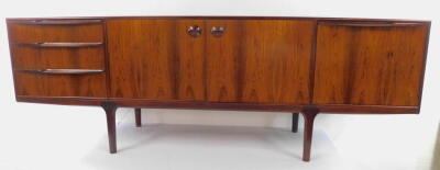 A McIntosh and Co Limited 1960's Rosewood dining suite, comprising a sideboard, with a pair of doors opening to reveal a shaped shelf, flanked to the left by three drawers, the top drawer fitted, to the right by a drop down flap revealing a drinks cabinet - 6