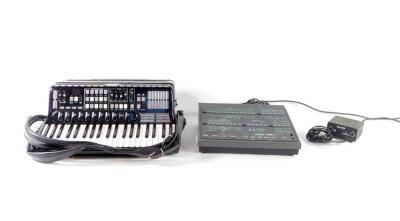 An Elka Cassotto midi piano accordion, with forty one keys, one hundred and twenty bass buttons and seven registers, cased, together with a midi power box and an Elka OMB3 synthesizer.