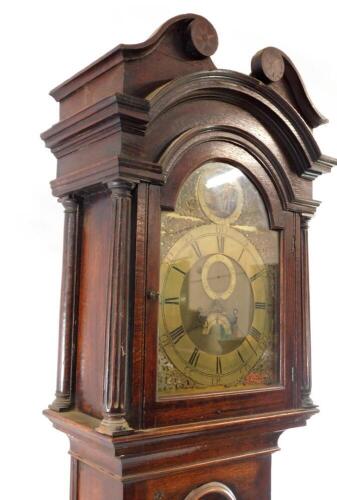 A Georgian oak cased longcase clock by Gamwel of Alford, the brass break arch dial with rococo scroll spandrels, chapter ring bearing Roman and Arabic numerals, subsidiary seconds and date dials, beneath a Tempus fugit circular aperture, painted with a wi