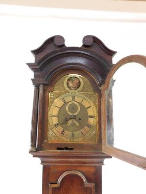 A Georgian oak cased longcase clock by Gamwel of Alford, the brass break arch dial with rococo scroll spandrels, chapter ring bearing Roman and Arabic numerals, subsidiary seconds and date dials, beneath a Tempus fugit circular aperture, painted with a wi - 3