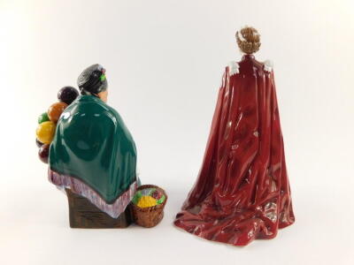 A Royal Doulton figure modelled as The Old Balloon Seller HN1315, together with a Royal Worcester porcelain figure of Her Majesty The Queen, in celebration of The Queens 80th Birthday 2006, dressed in the robes of the Order of the British Empire. (2) - 3