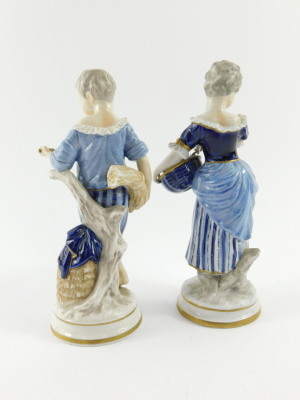 A pair of Unterweissbach 20thC porcelain figures, of a boy and girl, modelled standing with a sheath of corn and basket of grapes respectively, raised on circular bases, printed mark, 21cm high. - 3