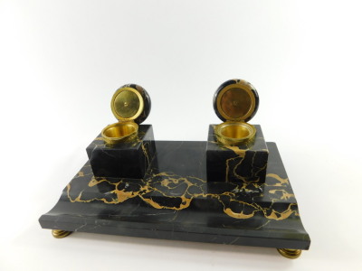 A French late 19thC veined black marble desk stand, with a pair of square integral inkwells with hinged gilt metal mounted lids, raised on a rectangular base with pen recess, on brass feet, 28cm wide, 17.5cm deep. - 2