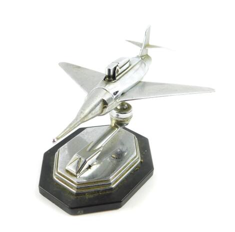 A 1950's Gala Sonic chrome aircraft desk top table lighter, raised on an octagonal plastic base, bears label 'Regd, Designs 869697 869675 880107/56 Pro. Patent 7599/56 As Applicable'., 23cm wide.