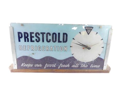 A mid 20thC Prestcold Refrigeration glass advertising clock, of rectangular section, with a circular dial against a turquoise and black wavy ground 'Prestcold Refrigeration, Keeps Our Food Fresh All The Time'., electric movement, on an oak base, 35.5cm hi