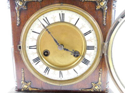 A German late 19thC oak and mahogany cased mantel clock, by the Hamburg American Clock Company, circular brass dial with enamelled chapter ring bearing Roman numerals, eight day movement with coil strike, the case of architectural form, no. 1068, with key - 2