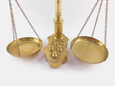 A set of brass balance scales, with weights, in an integral base, 55cm high. - 2