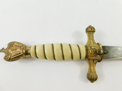 A Third Reich Kriegsmarine dagger, with gilt wire bound ivory grip, topped by a Swastika pommel, and etched steel blade, by Eickhorn, Solingen, 38cm wide. (AF) - 6