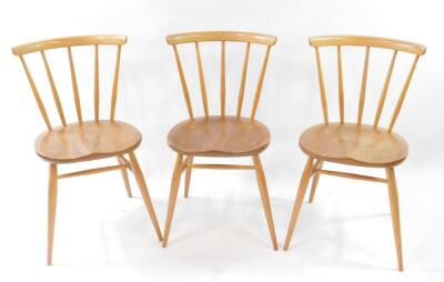 A set of three Ercol blonde elm and beech single dining chairs.