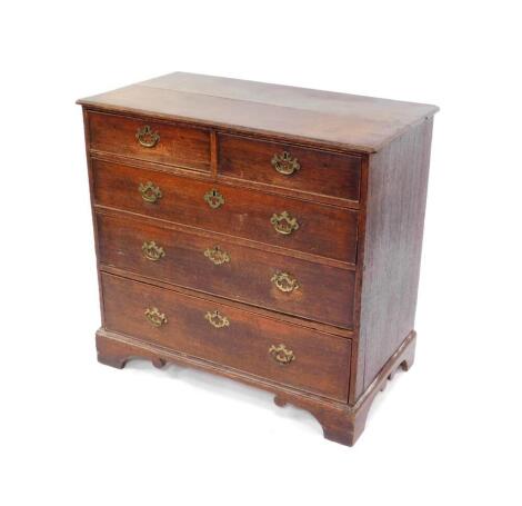 A George III oak chest, of two short over three long graduated drawers, raised on bracket feet, 90cm high, 96cm wide, 52cm deep.