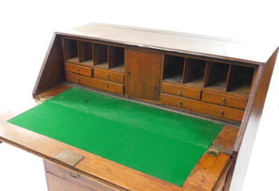 A George III oak bureau, the fall flap opening to reveal a central door, eight recesses and six drawers, over four long graduated drawers raised on bracket feet, 91.5cm high, 99cm wide, 54cm deep. - 3