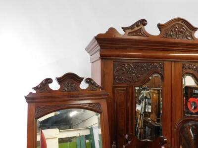 A Victorian walnut double wardrobe and dressing chest, by Blair and Kemp, Horncastle, the wardrobe with outswept pediment over a pair of carved and mirror set doors, the doors opening to reveal hanging hooks over a pair of deep drawers raised on a plinth - 3