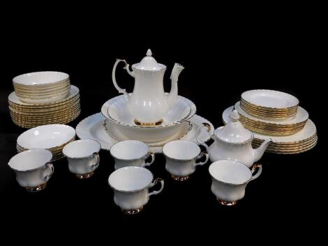 A Royal Albert porcelain part dinner, tea and coffee service, decorated in the Val D'or pattern, seconds, comprising oval meat platter, a pair of graduated circular dishes, six dinner, dessert and side plates, twelve soup bowls, six fruit bowls, bread pla