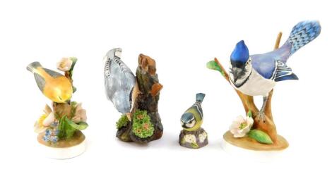 A Crown Staffordshire porcelain figure of a blue jay, modelled by Doris Lindner, printed and painted marks, a nuthatch modelled by J Bromley and a warbler modelled by Linley Adams, together with a Royal Worcester porcelain figure modelled as a blue tit. (