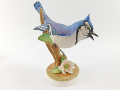 A Crown Staffordshire porcelain figure of a blue jay, modelled by Doris Lindner, printed and painted marks, a nuthatch modelled by J Bromley and a warbler modelled by Linley Adams, together with a Royal Worcester porcelain figure modelled as a blue tit. ( - 8