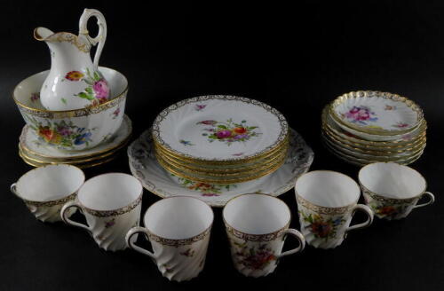 A group of Dresden porcelain tea and coffee wares, painted with sprays of flowers, gilt heightened, comprising bread plate, milk jug and sugar bowl, seven cups, eight saucers and nine tea plates.