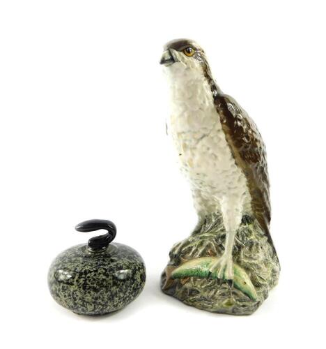 A Beswick Beneagles scotch whiskey decanter, modelled as an osprey, designed by D Lyttleton 1977, and a further Beneagles scotch whiskey decanter for Peter Thomson (Perth Limited) modelled as a curling stone. (2)