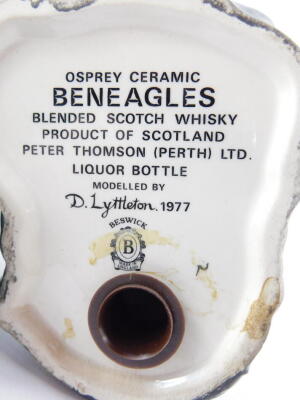 A Beswick Beneagles scotch whiskey decanter, modelled as an osprey, designed by D Lyttleton 1977, and a further Beneagles scotch whiskey decanter for Peter Thomson (Perth Limited) modelled as a curling stone. (2) - 4