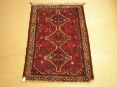 A Persian rug, the central pole medallion on a red ground<br